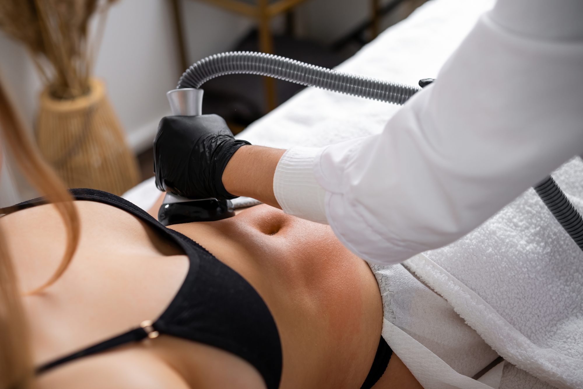 Provider gliding a CellSound ultrasound applicator over a patient's abdomen during non-invasive body contouring in Katonah, NY