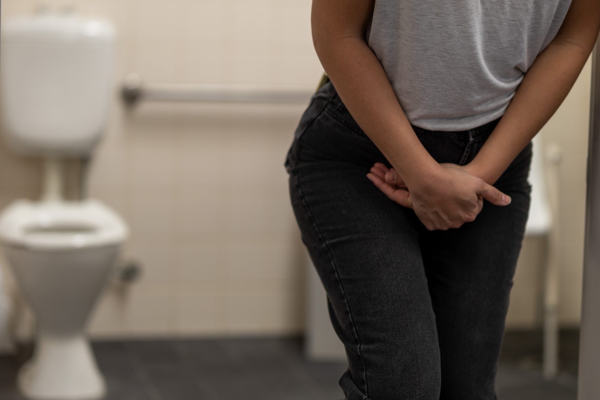 Woman experiencing urinary urgency, a symptom Emsella treats at Form & Function near Yorktown, NY