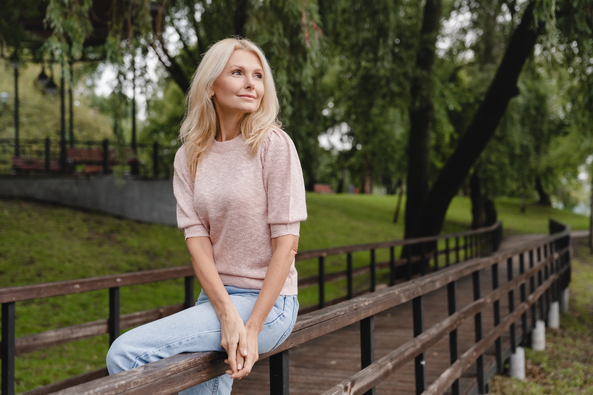 Midlife woman relaxing outdoors, representing whole-person menopause and perimenopause care in Katonah, NY