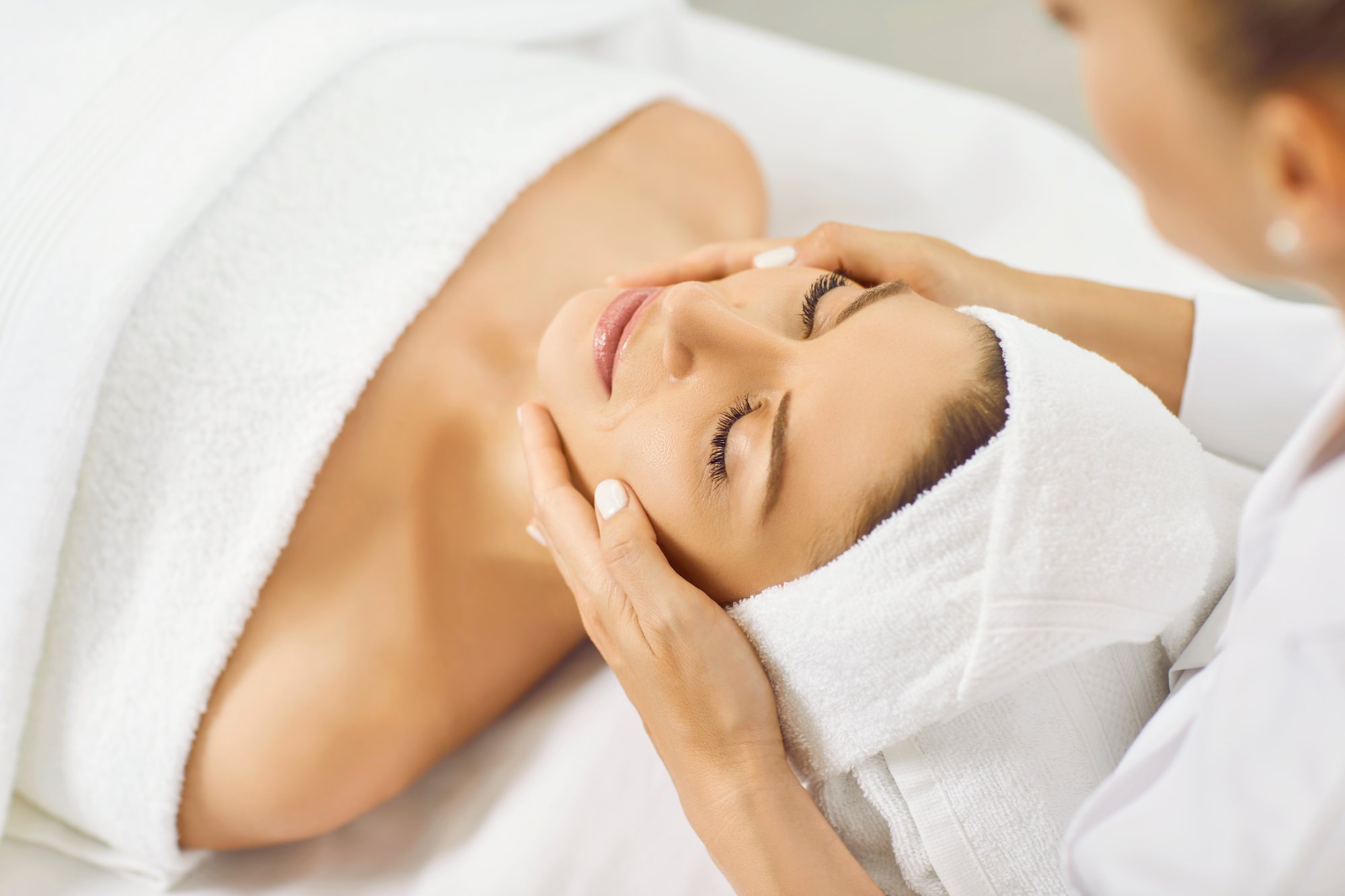 Aesthetician performing a professional facial treatment on a relaxed patient at Form & Function in Katonah, NY
